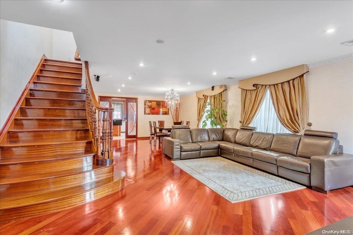 153-02 77th Avenue Queens, NY 11367 - Photo 2 of 23 a living room with furniture and wooden floor