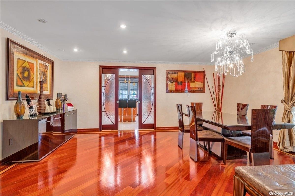 153-02 77th Avenue Queens, NY 11367 - Photo 5 of 23 a dining room with furniture a chandelier and wooden floor