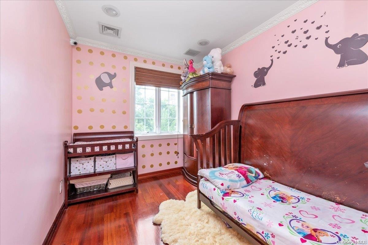 153-02 77th Avenue Queens, NY 11367 - Photo 8 of 23 a bedroom with a bed and a dresser in it