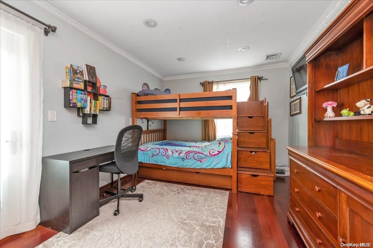 153-02 77th Avenue Queens, NY 11367 - Photo 9 of 23 a bedroom with a workspace