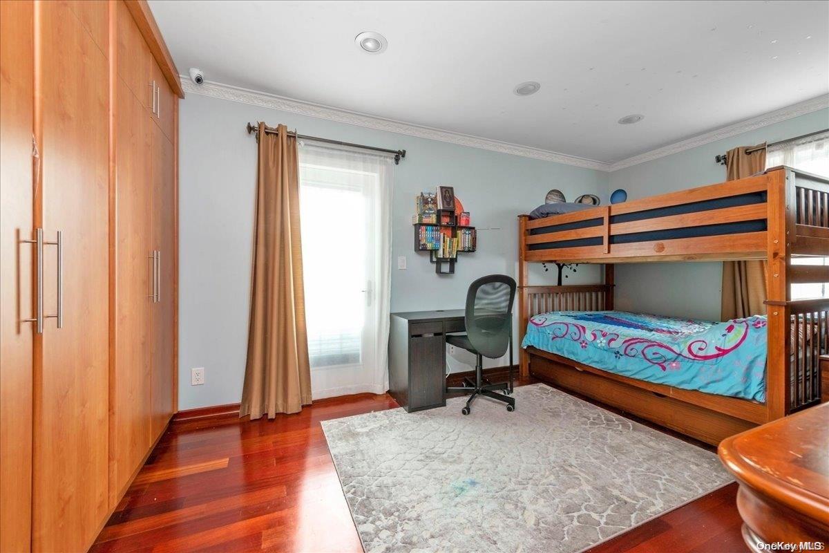 153-02 77th Avenue Queens, NY 11367 - Photo 10 of 23 a bedroom with furniture and a gate