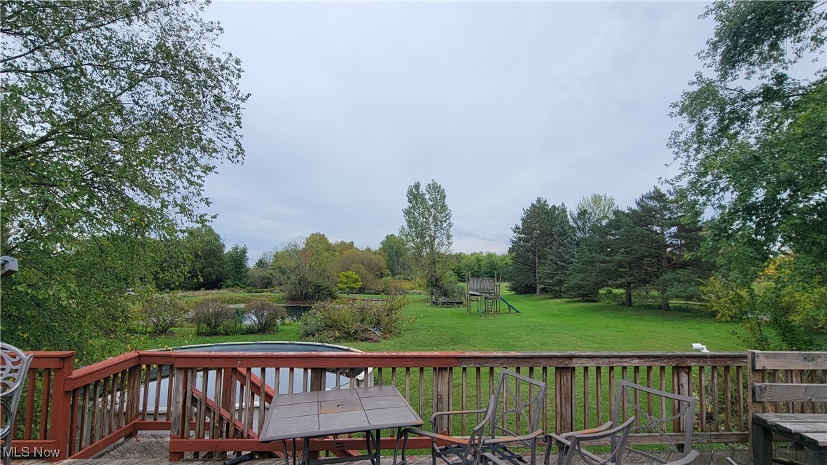 4133 Beat Road Litchfield, OH 44253 - Photo 6 of 25 Deck featuring a lawn and a playground