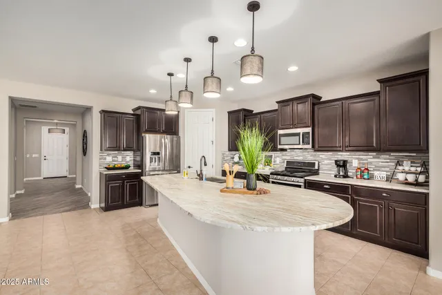 a kitchen with sink stove and cabinets