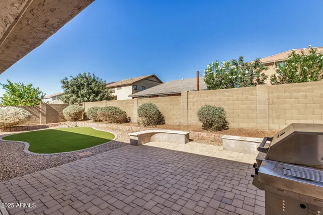 a view of a backyard with plants and a patio
