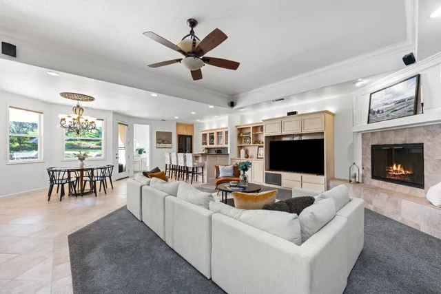 a living room with furniture a fireplace and a flat screen tv