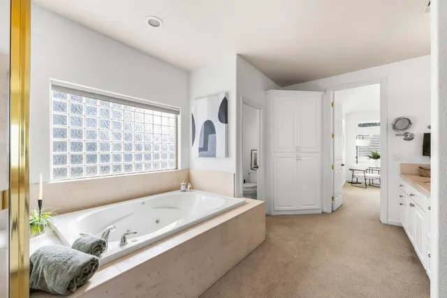 a spacious bathroom with a tub sink and shower