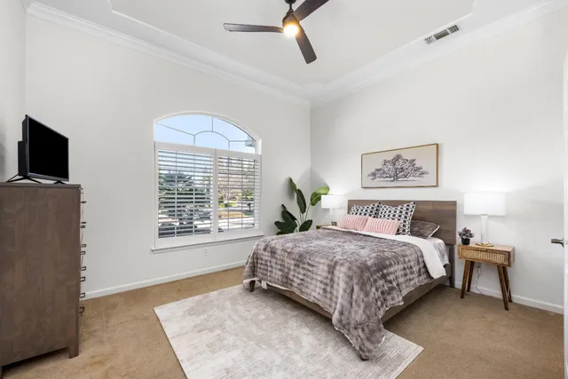 a bedroom with a bed a couch and a window