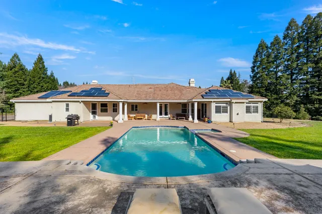 a front view of a house with a yard table and chairs