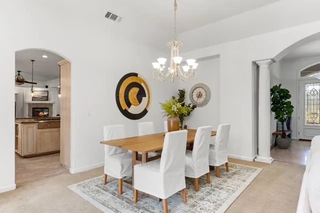 a living room with fireplace furniture and decor