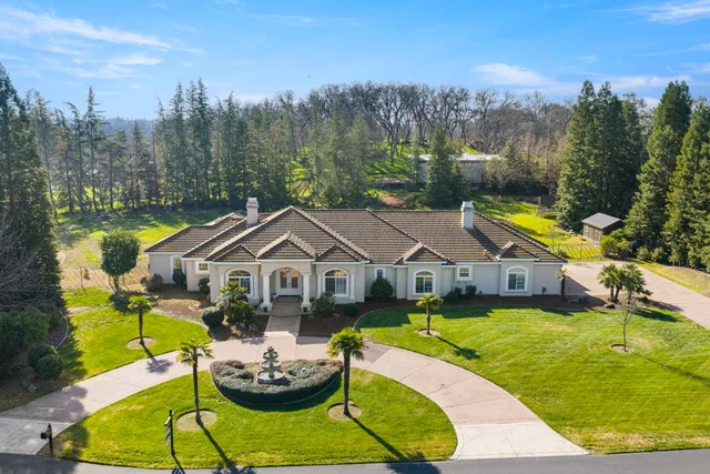 a aerial view of a house with swimming pool and furniture
