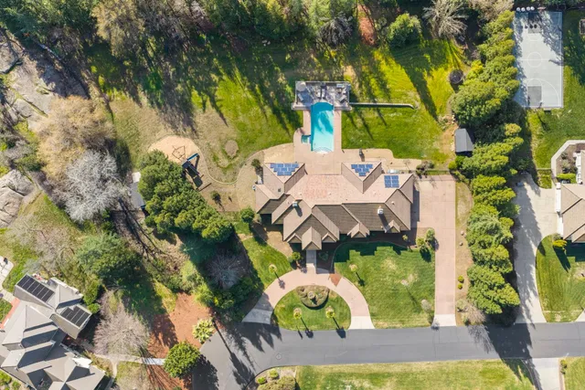 an aerial view of a house with yard swimming pool and outdoor seating