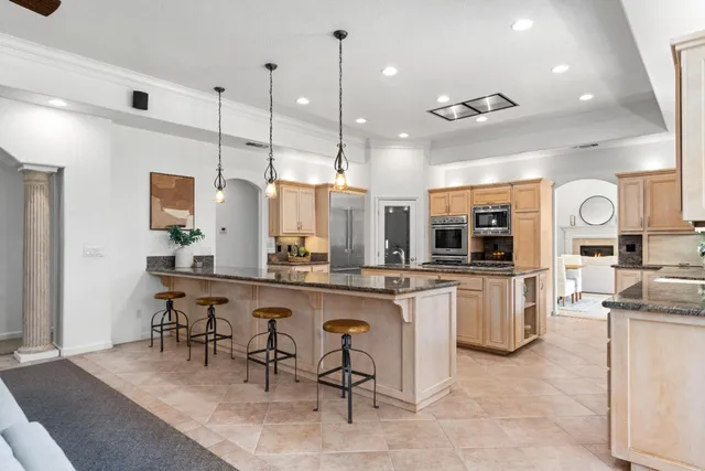 a large kitchen with a table and chairs in it