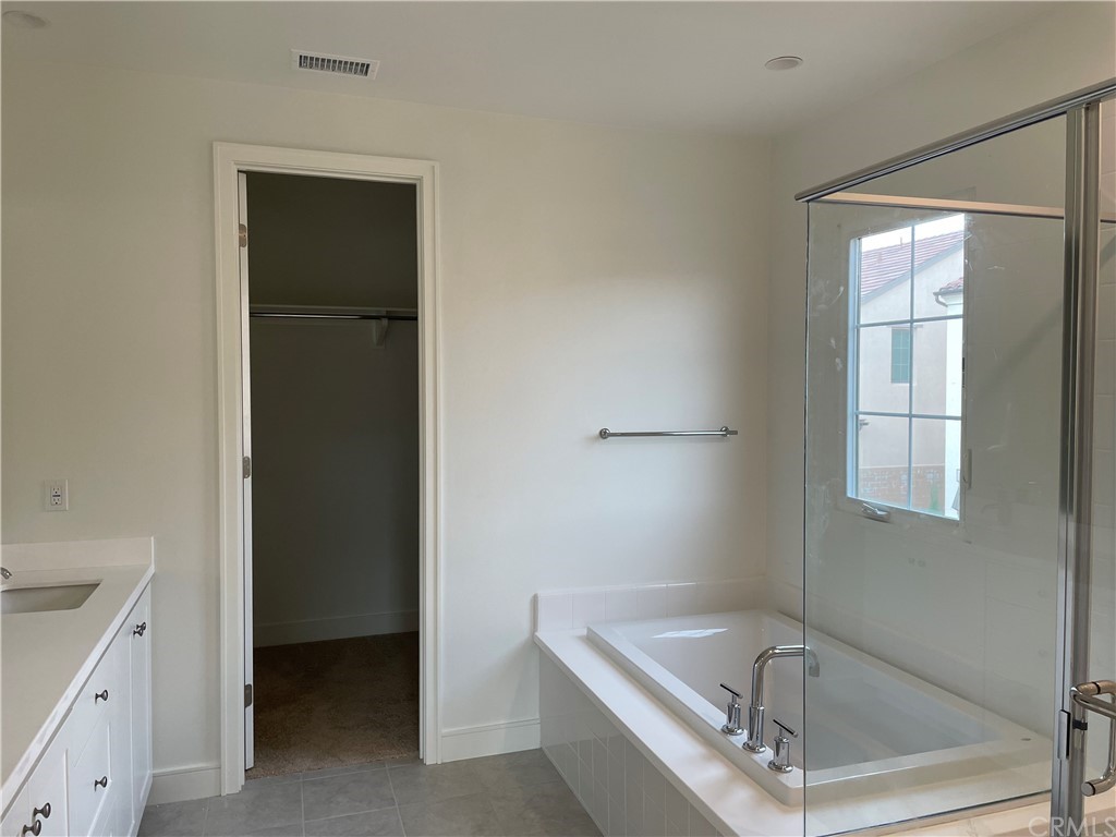 191 Oceano Irvine, CA 92602 - Photo 11 of 11 a bathroom with a tub a sink and a window