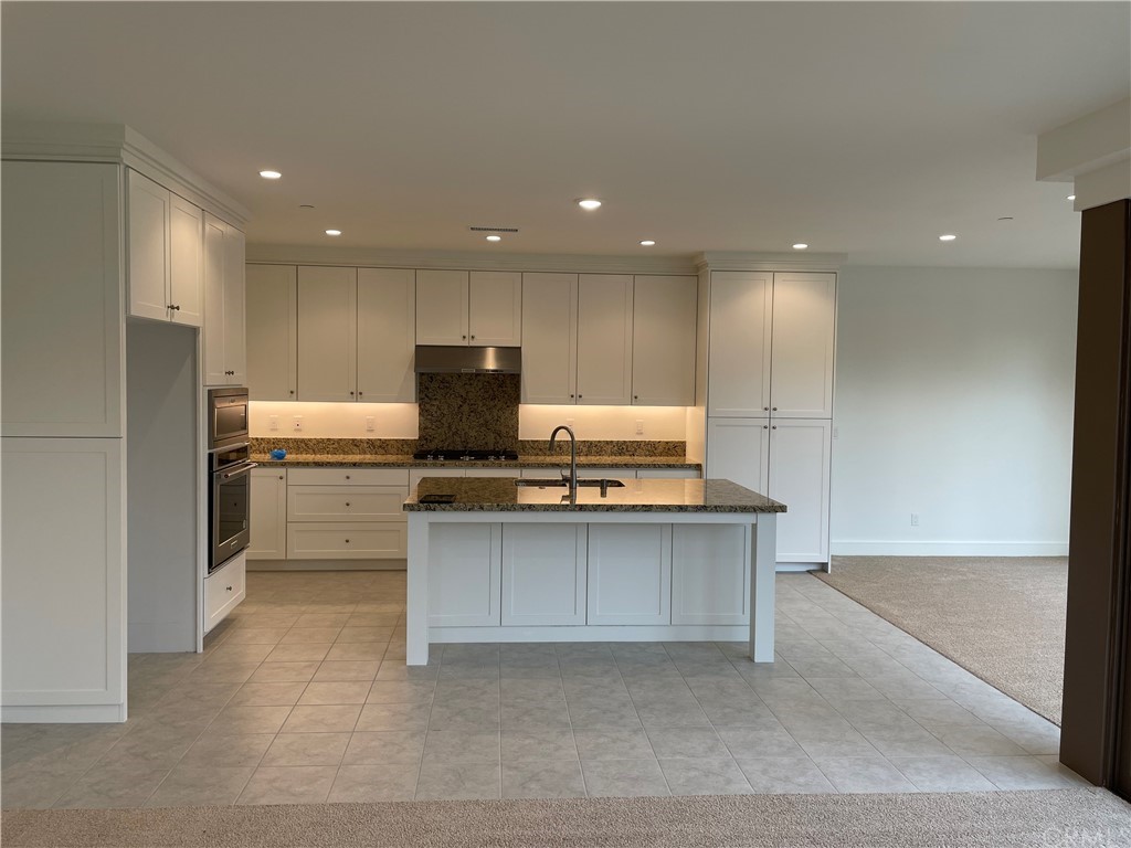 191 Oceano Irvine, CA 92602 - Photo 4 of 11 a kitchen with kitchen island a sink stainless steel appliances and cabinets