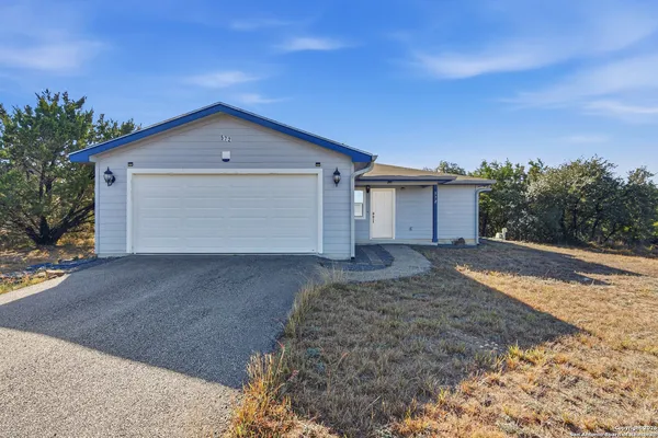 a view of a house with a yard and garage