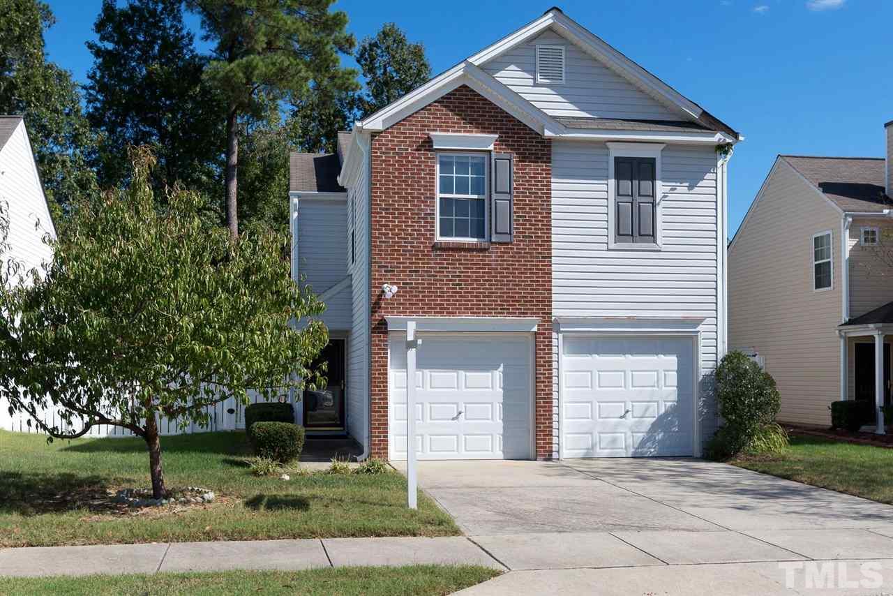 8120 Tara Ridge Road Raleigh, NC 27616 - Photo 1 of 22 a front view of a house with a yard and trees
