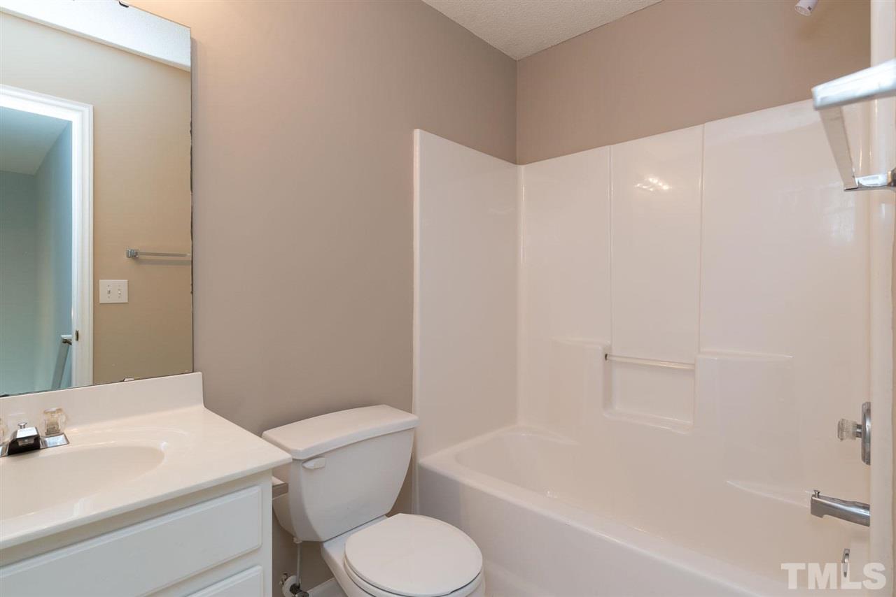 8120 Tara Ridge Road Raleigh, NC 27616 - Photo 14 of 22 a white toilet sitting next to a bath tub