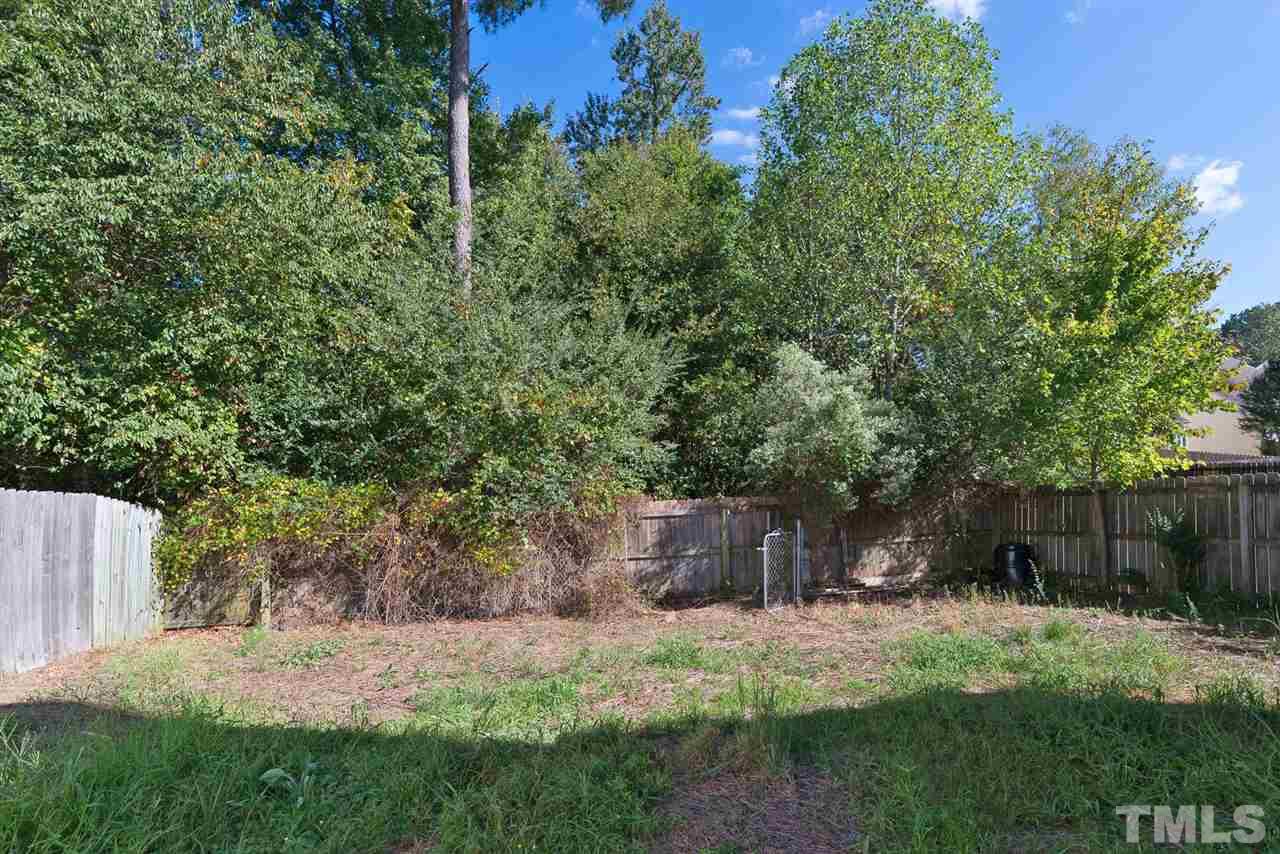 8120 Tara Ridge Road Raleigh, NC 27616 - Photo 20 of 22 a view of a backyard with large trees and plants