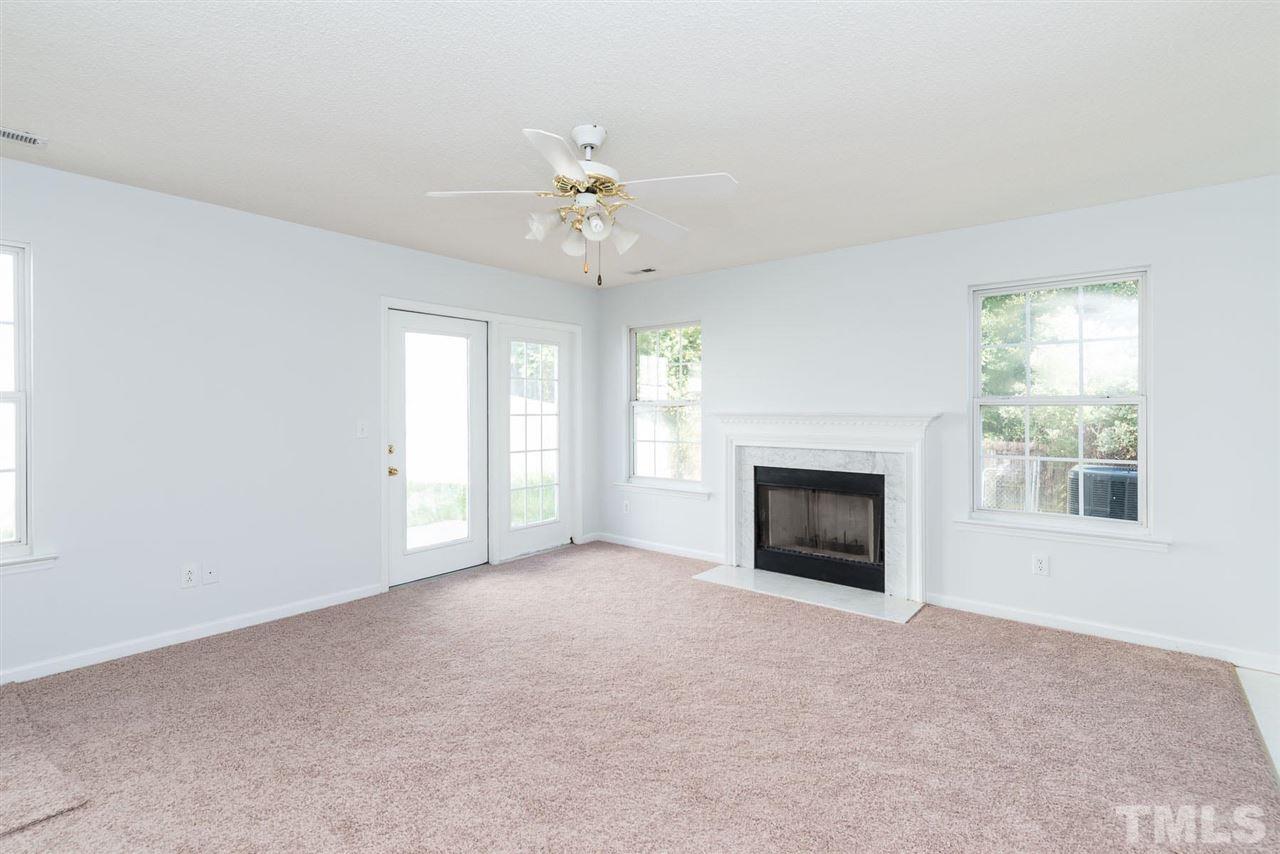 8120 Tara Ridge Road Raleigh, NC 27616 - Photo 4 of 22 an empty room with windows and fireplace