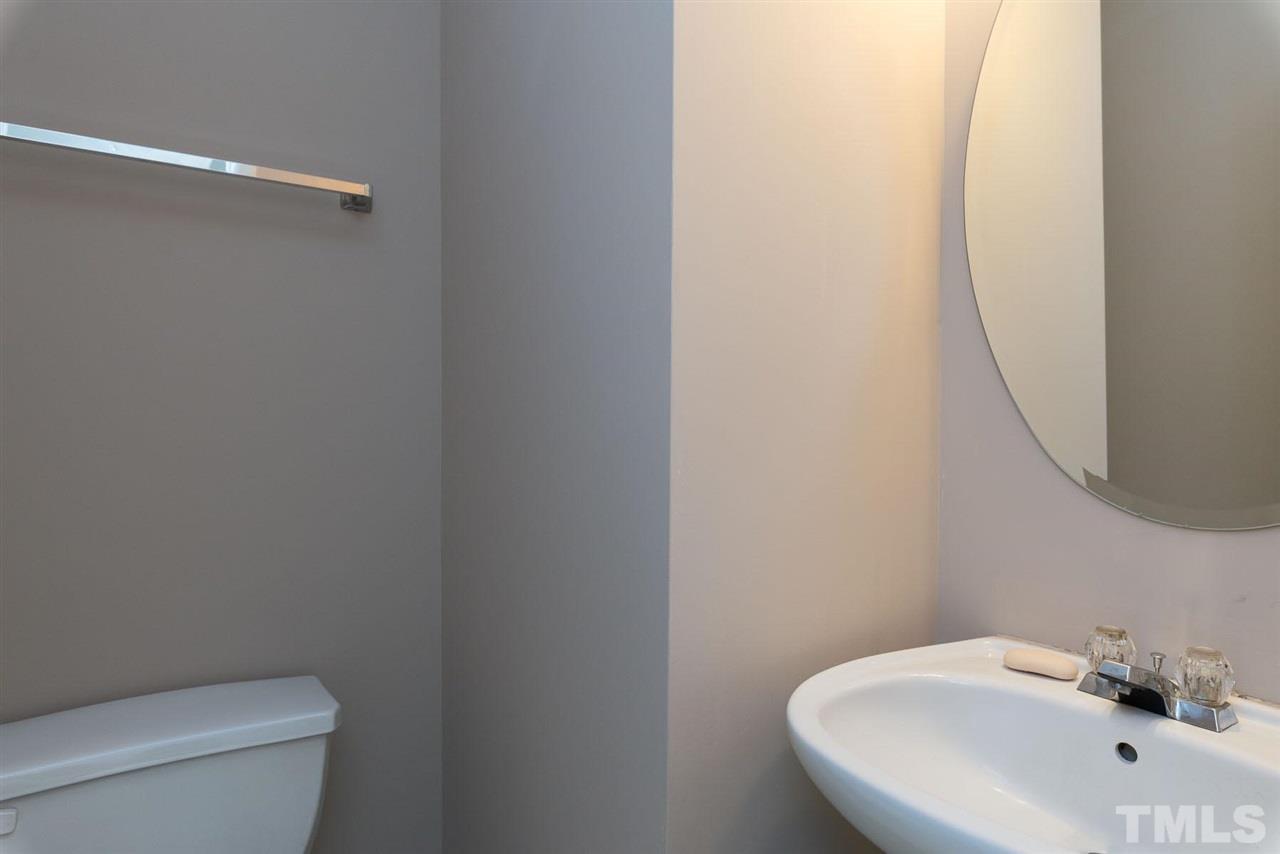 8120 Tara Ridge Road Raleigh, NC 27616 - Photo 9 of 22 a bathroom with a white toilet and a sink