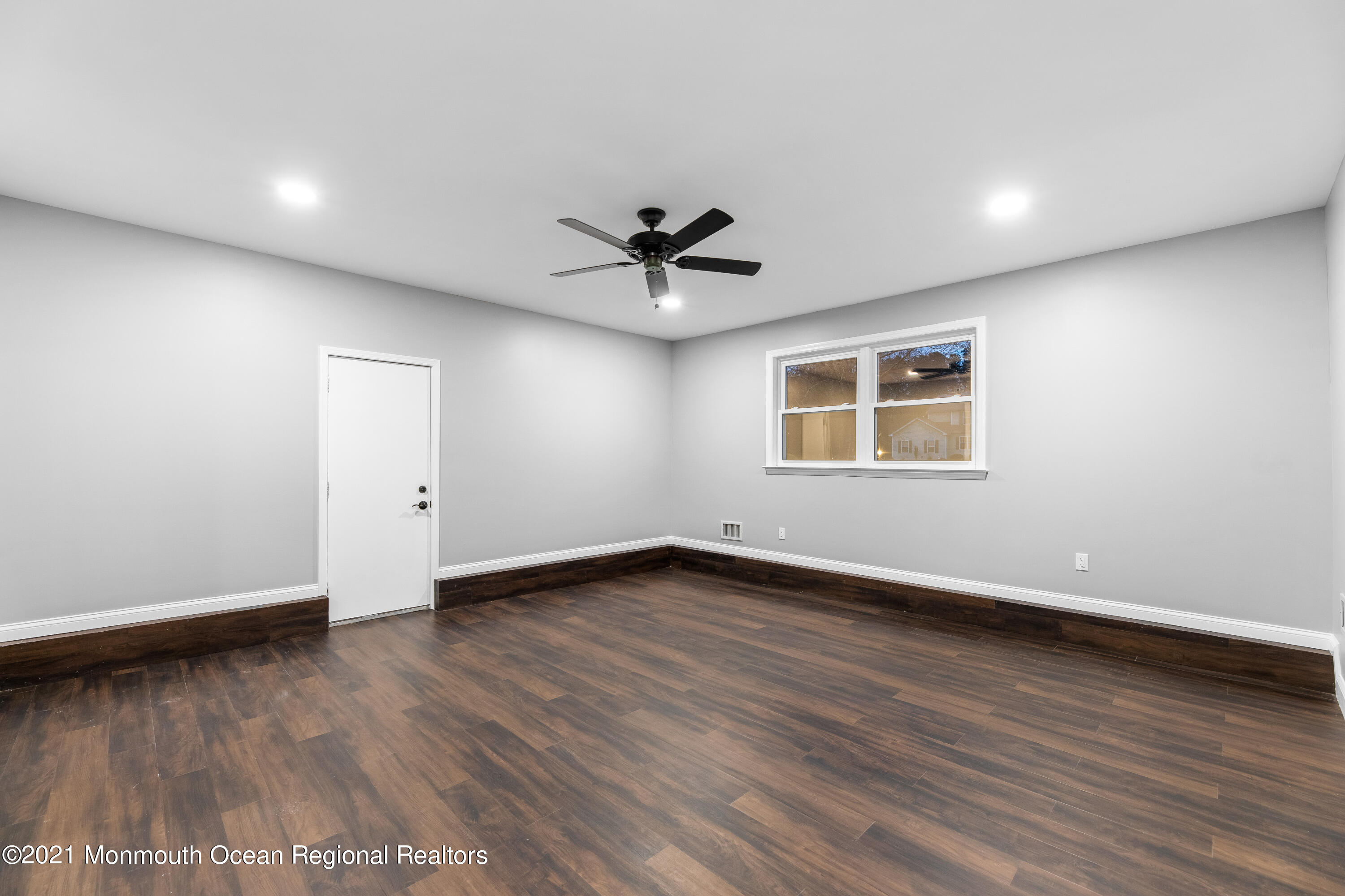 26 Squan Road Millstone Township, NJ 08510 - Photo 13 of 24 an empty room with wooden floor and ceiling fan