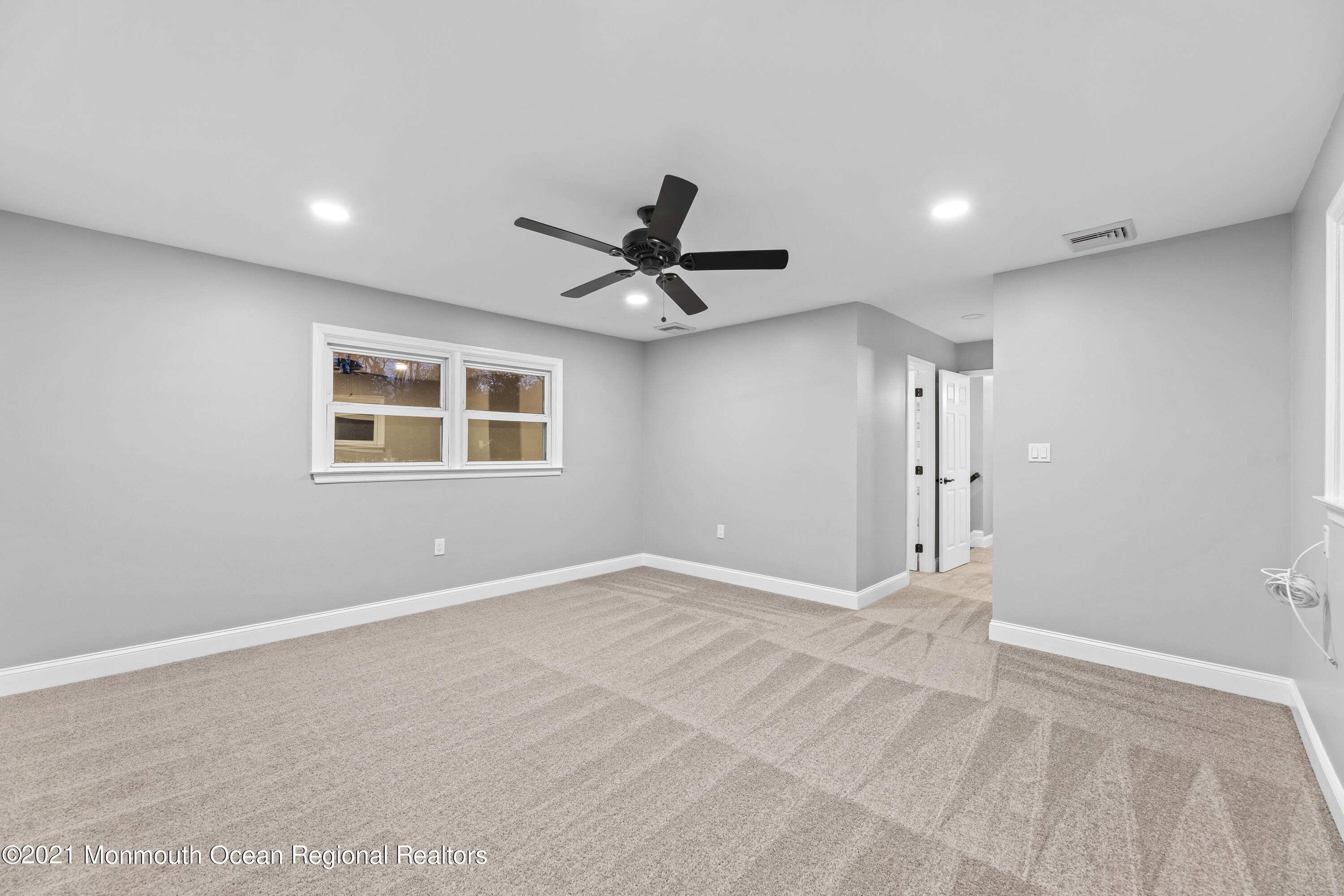 26 Squan Road Millstone Township, NJ 08510 - Photo 16 of 24 a view of an empty room with a ceiling fan