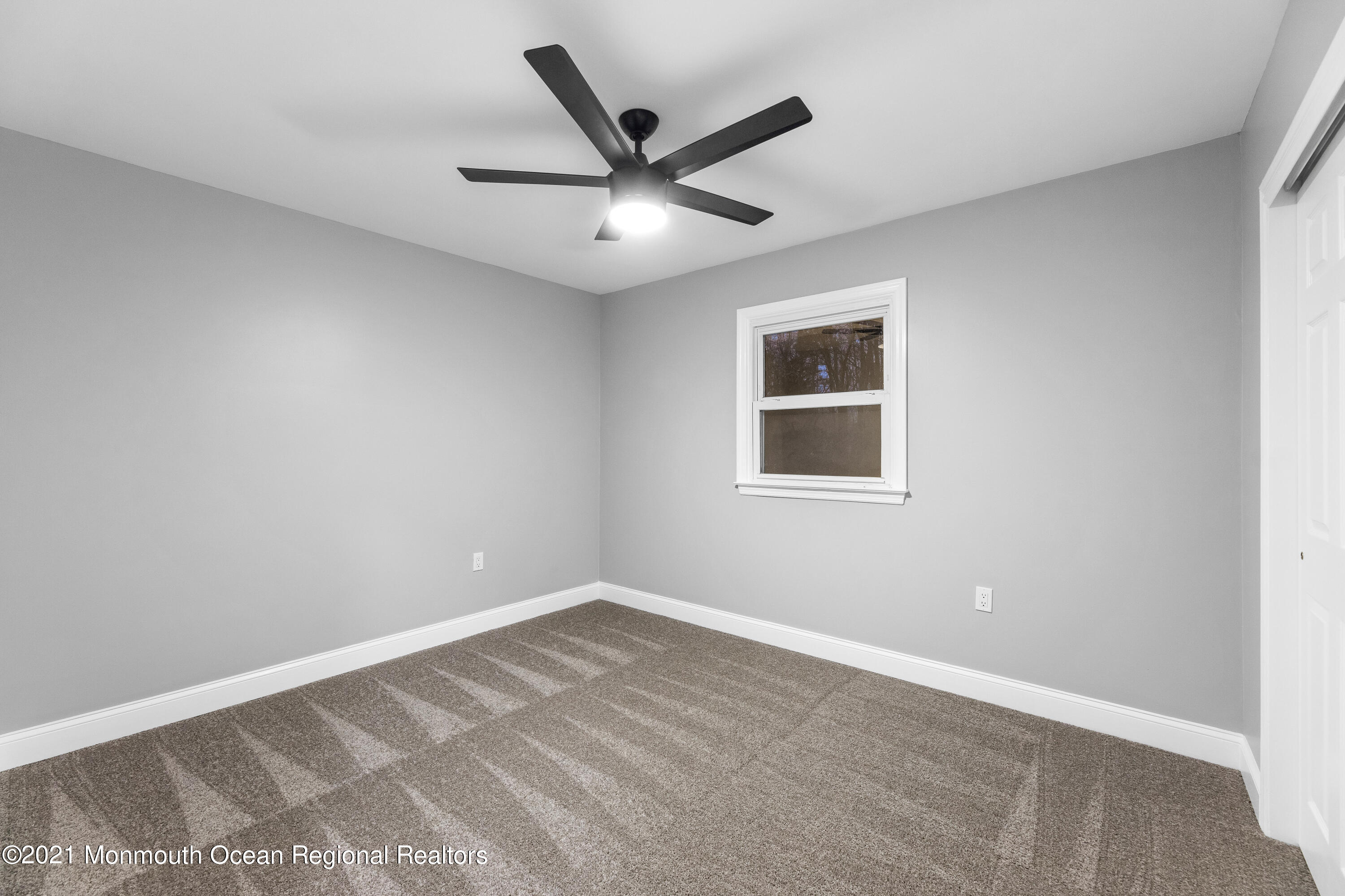 26 Squan Road Millstone Township, NJ 08510 - Photo 20 of 24 a view of a big room with wooden floor and a ceiling fan
