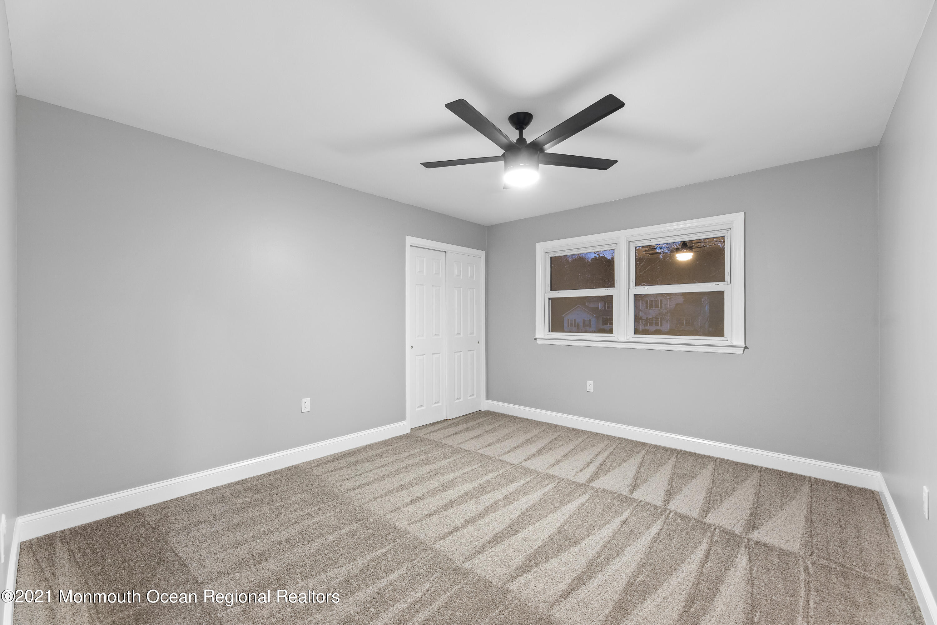 26 Squan Road Millstone Township, NJ 08510 - Photo 21 of 24 a view of an empty room with window and wooden floor