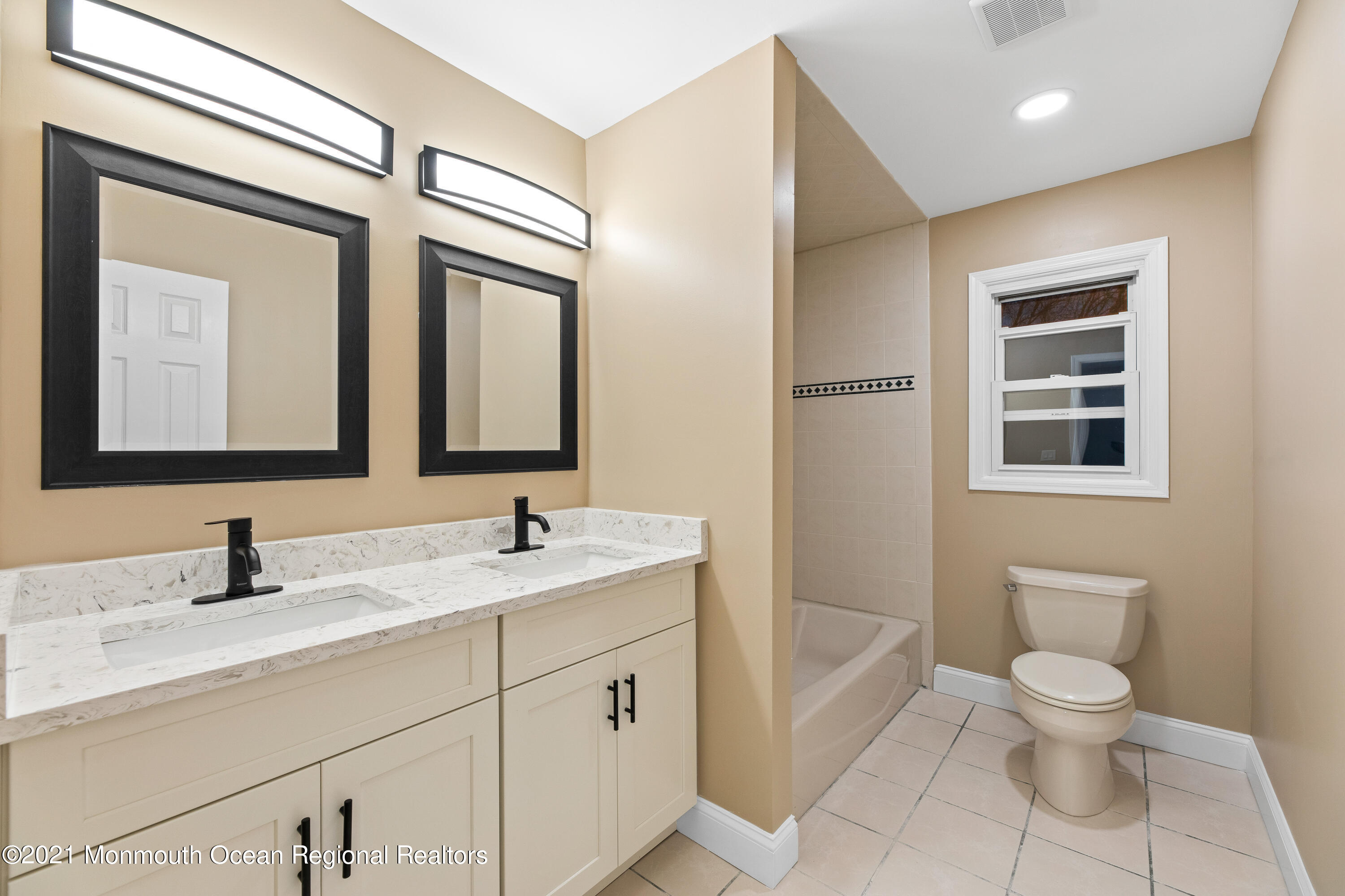 26 Squan Road Millstone Township, NJ 08510 - Photo 23 of 24 a bathroom with a toilet a sink a mirror and a shower