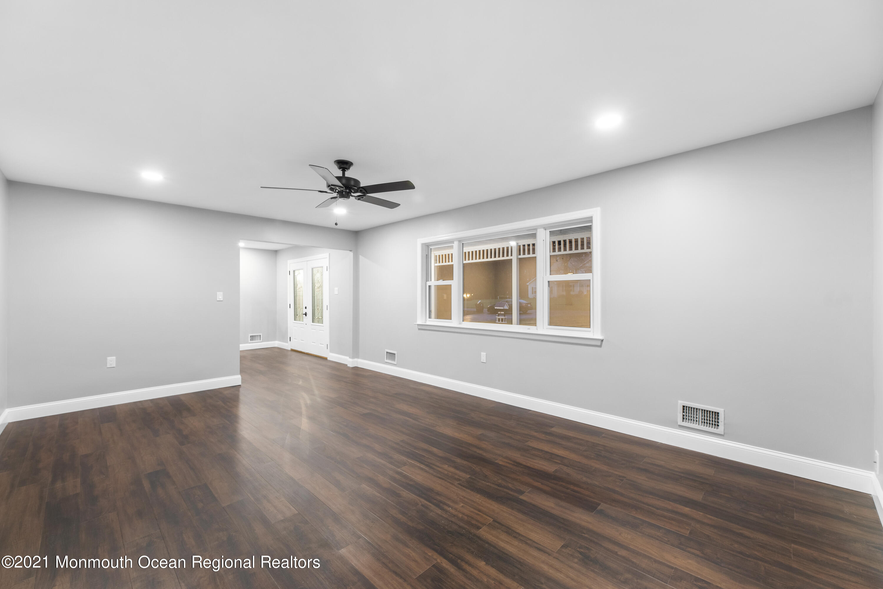 26 Squan Road Millstone Township, NJ 08510 - Photo 4 of 24 a view of an empty room with wooden floor and a window