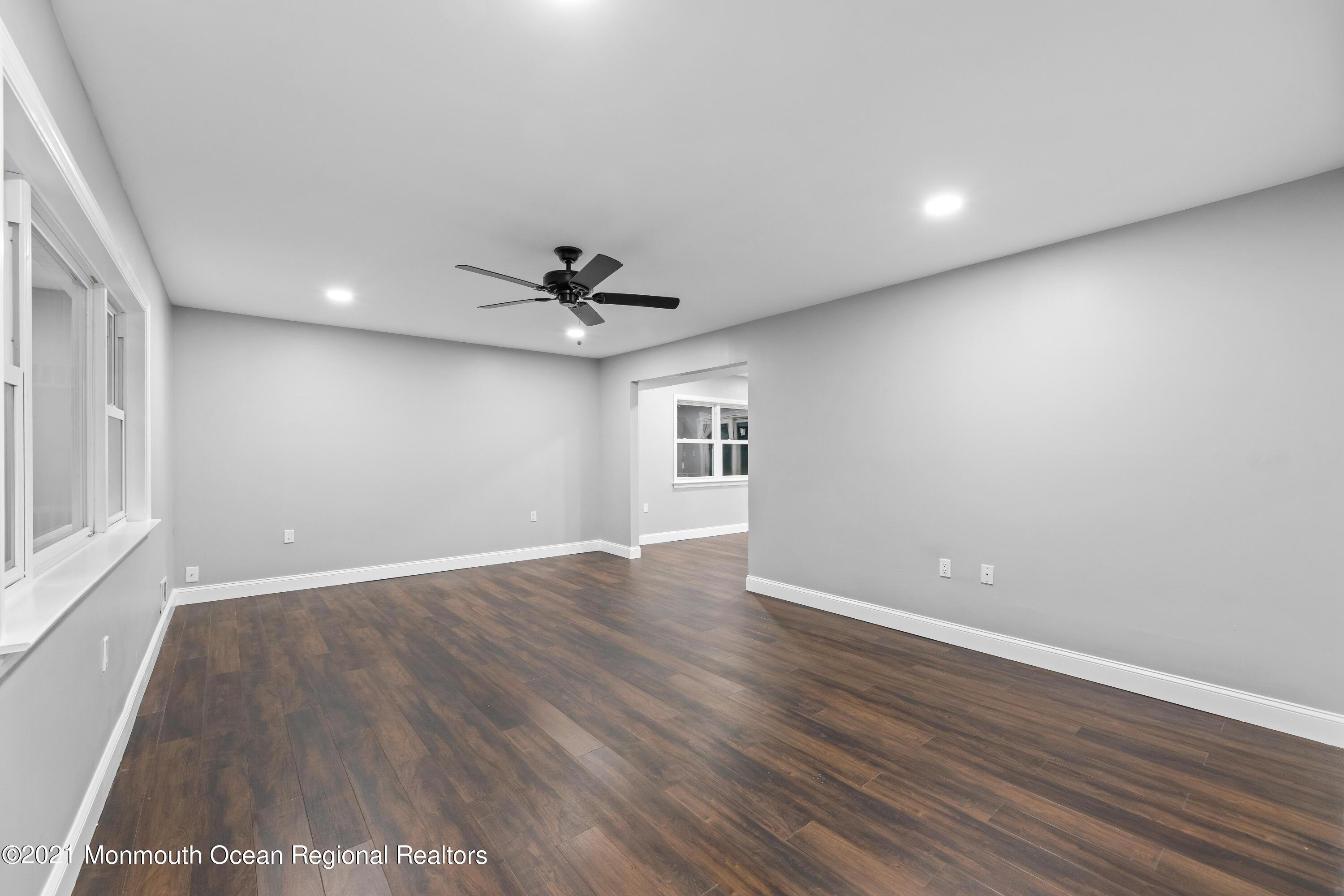 26 Squan Road Millstone Township, NJ 08510 - Photo 5 of 24 a view of an empty room with wooden floor and a window