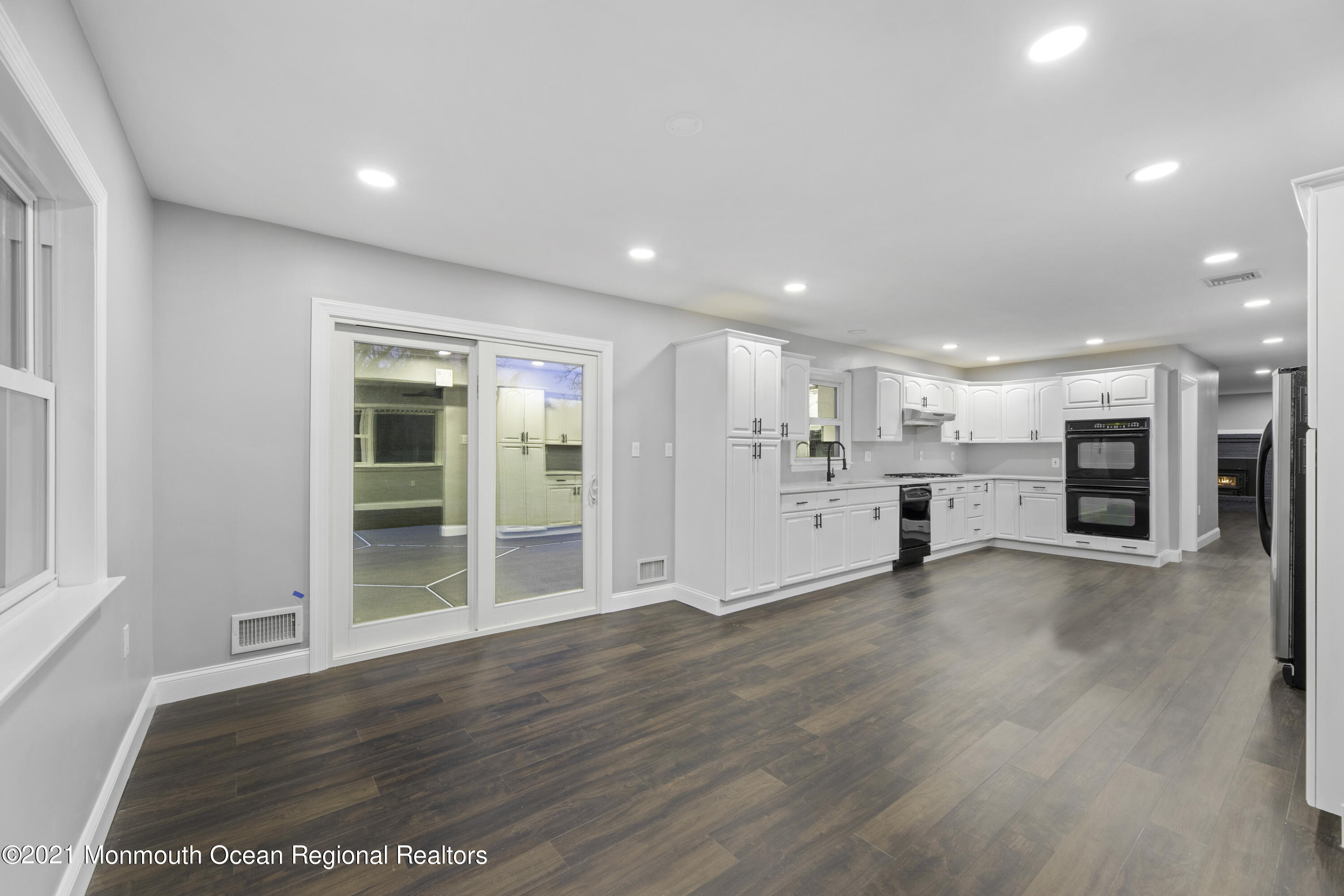 26 Squan Road Millstone Township, NJ 08510 - Photo 7 of 24 a view of an empty room with wooden floor