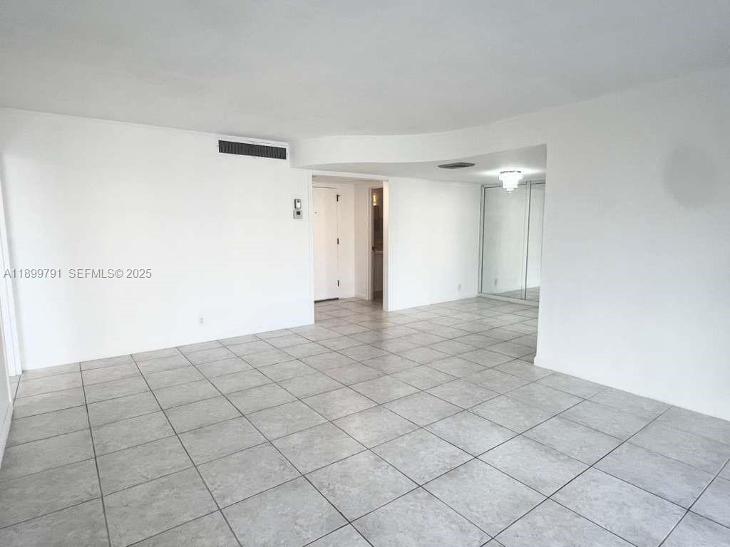100 Golden Isles Drive, Unit 406 Hallandale Beach, FL 33009 - Photo 13 of 31 a view of a livingroom with an empty space and a more cabinets