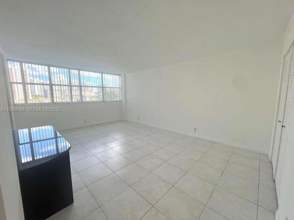 100 Golden Isles Drive, Unit 406 Hallandale Beach, FL 33009 - Photo 16 of 31 an empty room with windows
