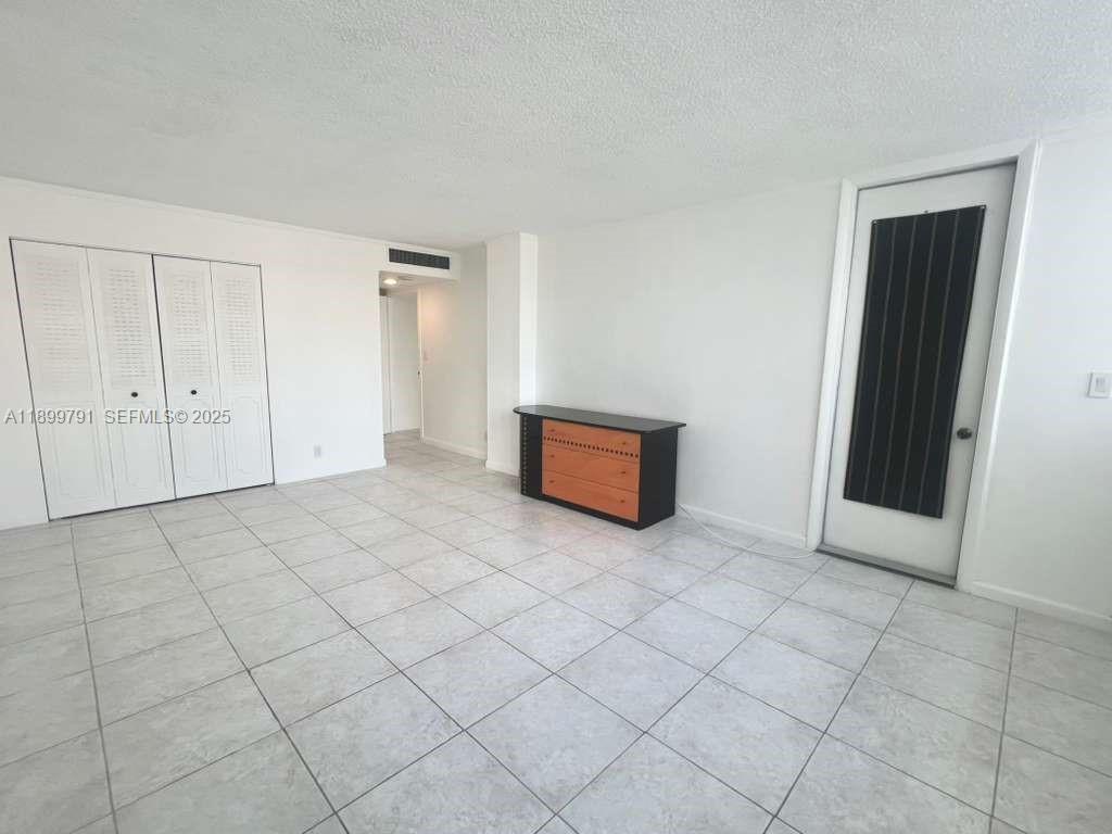 100 Golden Isles Drive, Unit 406 Hallandale Beach, FL 33009 - Photo 17 of 31 an empty room with windows