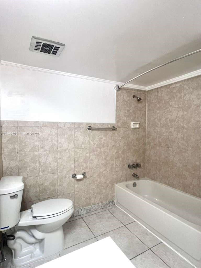 100 Golden Isles Drive, Unit 406 Hallandale Beach, FL 33009 - Photo 20 of 31 a bathroom with a toilet and a bathtub