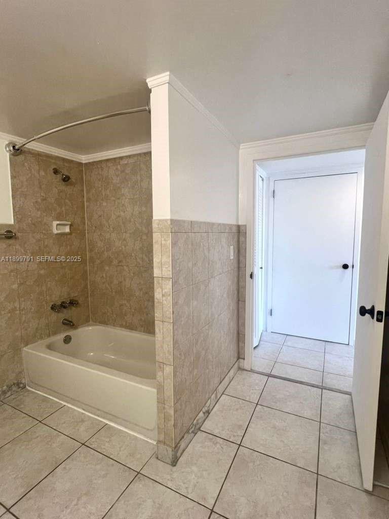 100 Golden Isles Drive, Unit 406 Hallandale Beach, FL 33009 - Photo 21 of 31 a bathroom with a bathtub and a shower