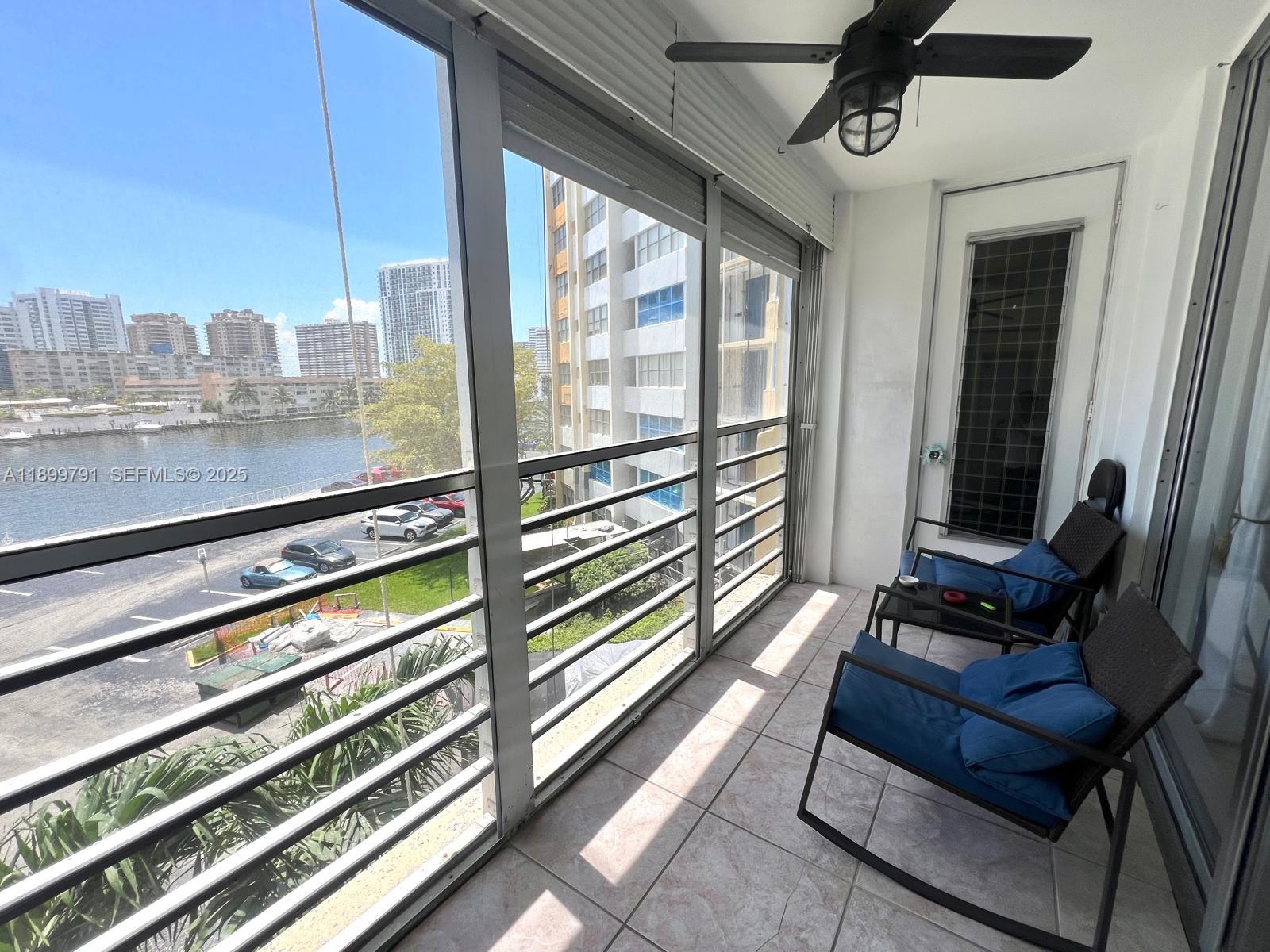 100 Golden Isles Drive, Unit 406 Hallandale Beach, FL 33009 - Photo 23 of 31 a view of a living room with furniture and a window