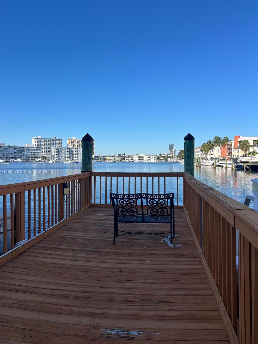 100 Golden Isles Drive, Unit 406 Hallandale Beach, FL 33009 - Photo 28 of 31 a view of balcony with wooden floor and city view