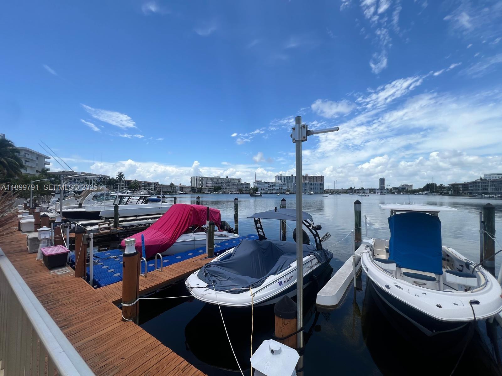 100 Golden Isles Drive, Unit 406 Hallandale Beach, FL 33009 - Photo 29 of 31 a terrace with outdoor seating and city view