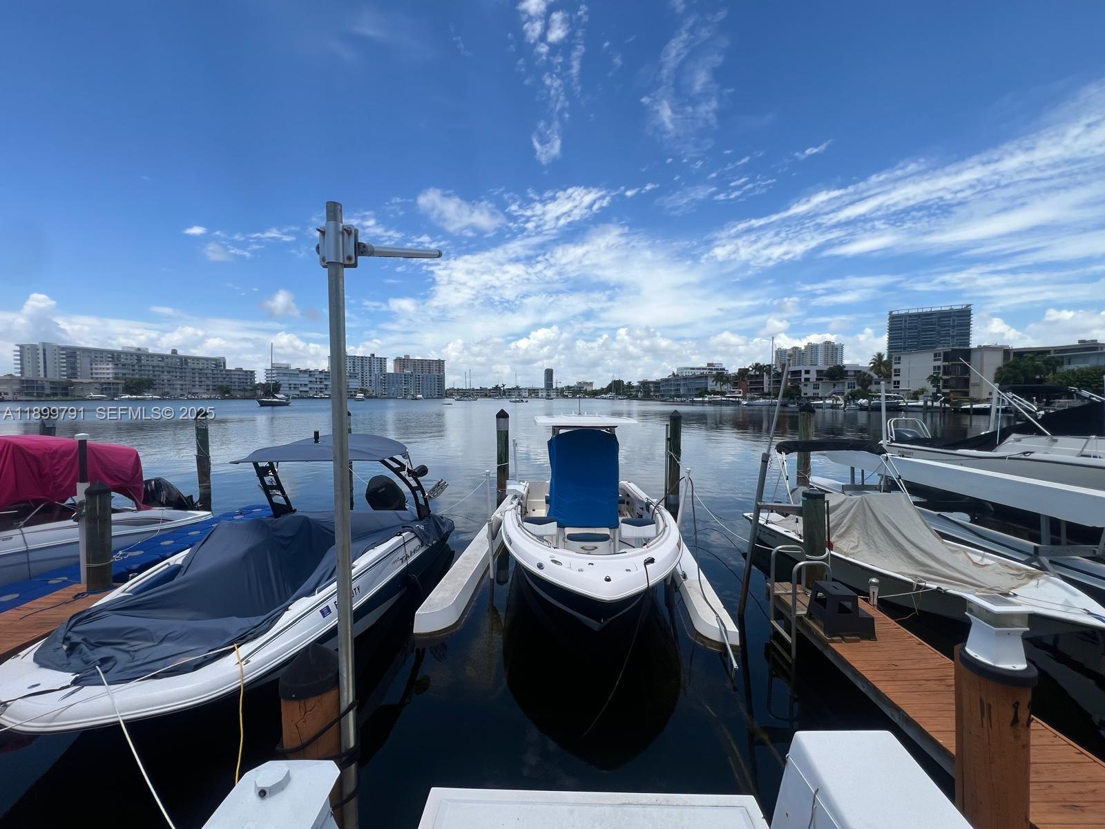 100 Golden Isles Drive, Unit 406 Hallandale Beach, FL 33009 - Photo 30 of 31 a dining room with furniture and a kitchen view