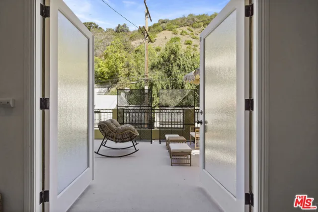 a view of a balcony and dining room