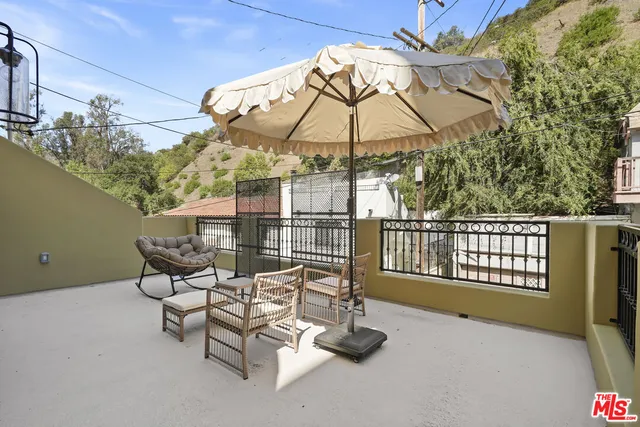 a view of a two chairs and table in the balcony