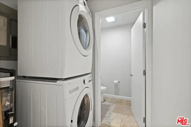 a view of a storage & utility room with dryer and washer