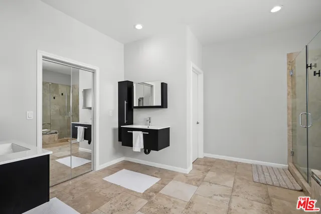 a view of an empty room and a gallery with wooden floor