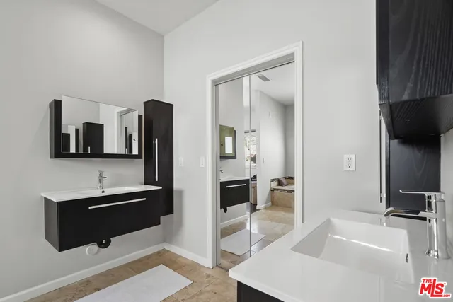 a spacious bathroom with a sink and a mirror