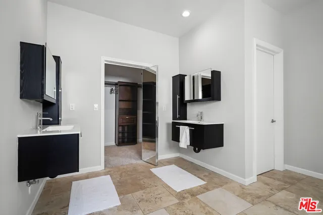 a bathroom with double vanity sink and mirror