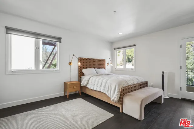 a bedroom with a bed lamp and window