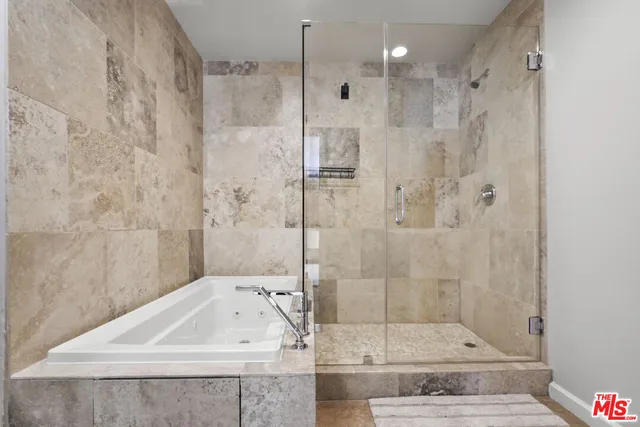 a bathroom with a sink a shower and bathtub