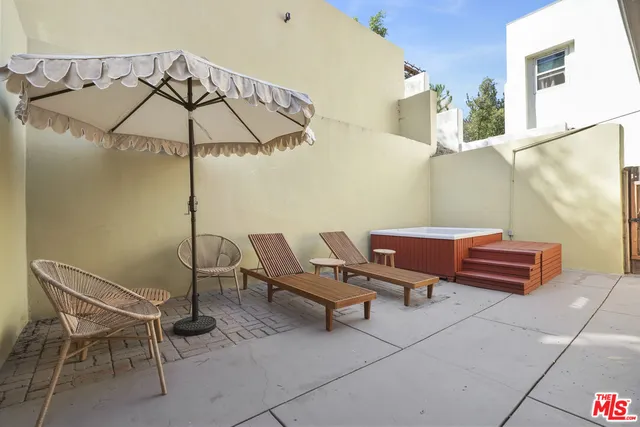 a couple of chairs sitting in patio of a house